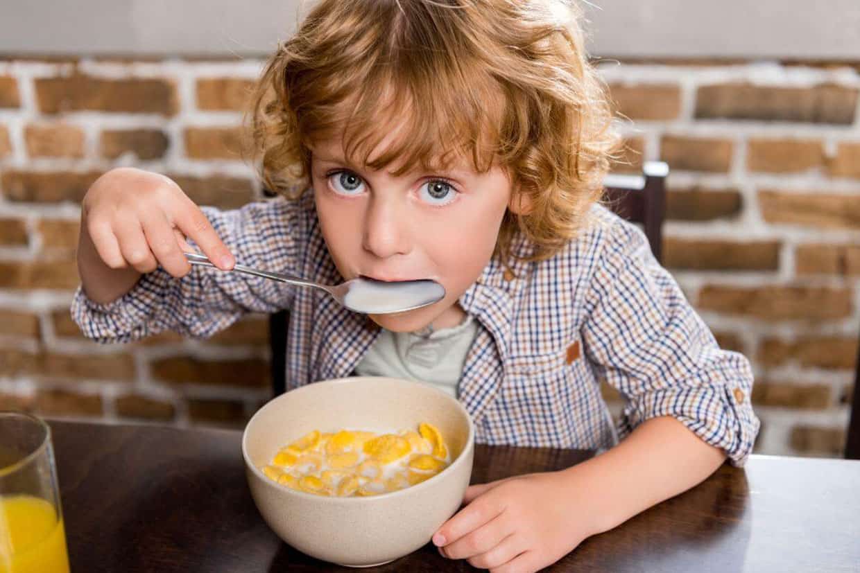 young boy eating cereals